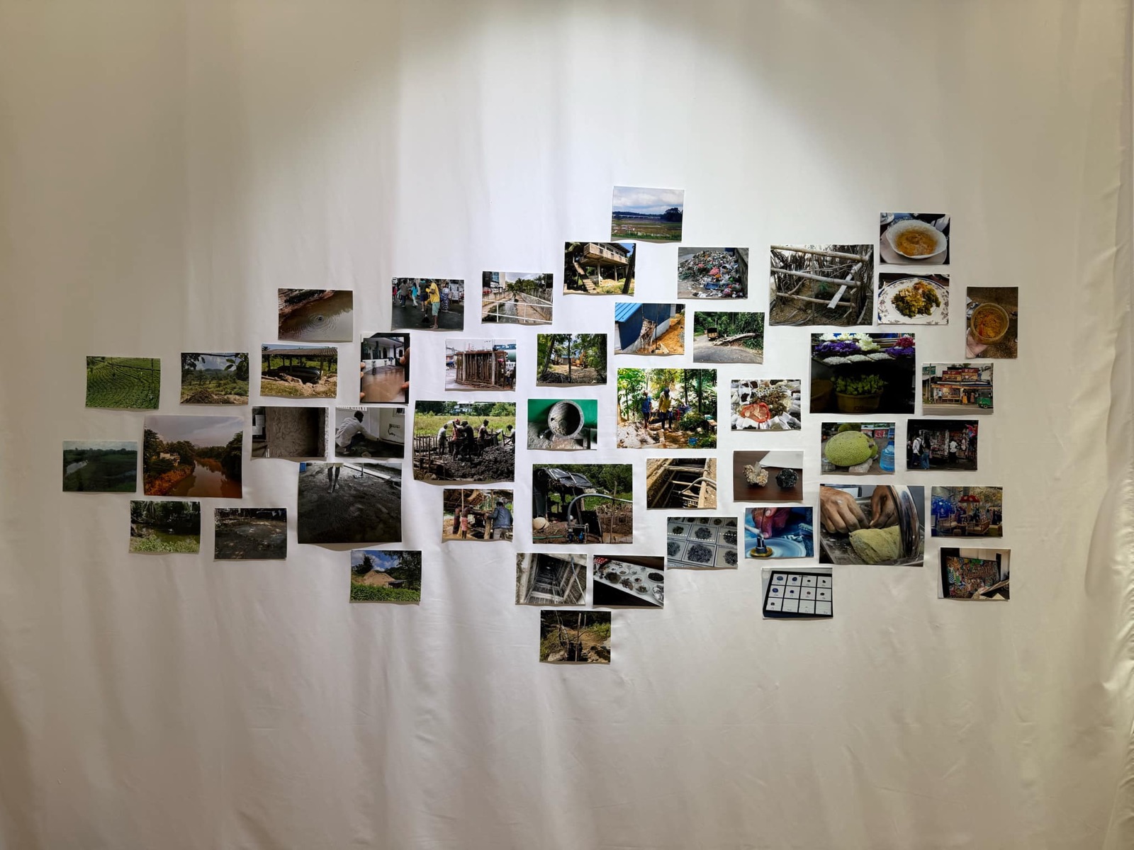 Shu Fujita&rsquo;s composition: photographs of mud, rivers, gemstones and food run from left to right on a white cloth